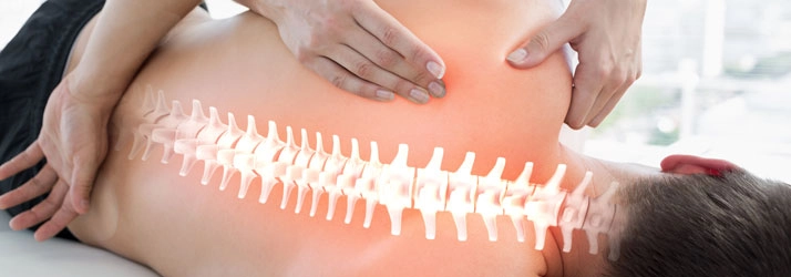 A person receiving a back massage with a digitally overlaid illustration of the spine, emphasizing spinal alignment and care.